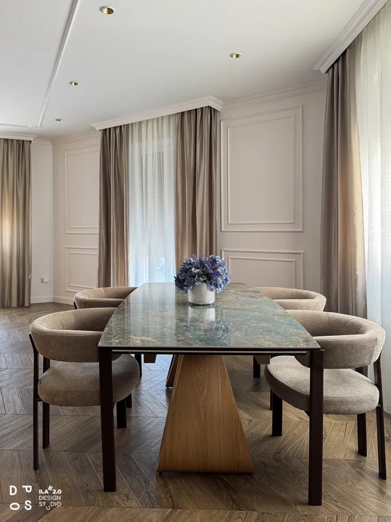 Tavolo da pranzo con piano in pietra e sedie imbottite in Casa F+D